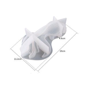 May include: A white silicone mould for making resin crafts. The mould is shaped like a flamingo with its legs bent and its head tilted back. The mould measures 11.2 inches by 4.8 inches by 19 inches.