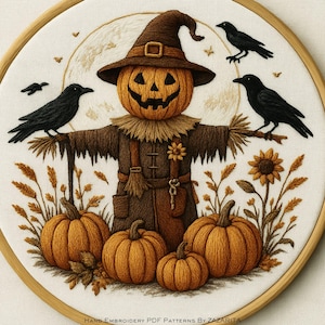 May include: Embroidered Halloween design featuring a scarecrow with a pumpkin head, wearing a brown hat and outfit. Three black crows perch on the scarecrow's arms. Orange pumpkins and a sunflower are at the base. The text "HAND EMBROIDERY PDF PATTERNS BY ZAZARITA" is at the bottom.