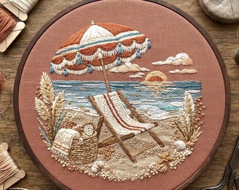 May include: A circular embroidery hoop featuring a beach scene on a terracotta fabric background. The design includes a striped beach umbrella, a wooden lounge chair, a woven basket with a towel, tall grasses, seashells, and a sunset over the sea.