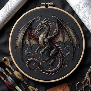May include: Embroidered dragon artwork in a wooden hoop. The dragon is black, gold, and red, with detailed wings and fiery breath. The embroidery is on dark grey fabric, with spools of thread and scissors nearby.