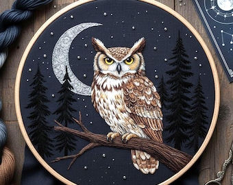 May include: An embroidered owl perched on a branch, set against a dark blue night sky with a crescent moon and pine trees. The owl has brown and white feathers, with yellow eyes. The embroidery is framed in a wooden hoop.