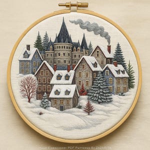 May include: An embroidered winter village scene in a wooden hoop. The artwork shows snow-covered houses, fir trees, and a castle with a dark spire. The text at the bottom reads "HAND EMBROIDERY PDF PATTERNS BY ZAZARITA."