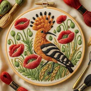 May include: An embroidered hoop art piece showing a hoopoe bird and red poppies. The bird has orange, black, and white markings. The poppies are red with green centers. Green leaves and wheat stalks surround the bird. Text at the bottom reads "HAND EMBROIDERY PDF PATTERNS BY ZAZARITA".
