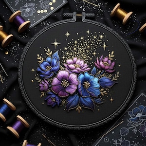 May include: A black embroidery hoop featuring a floral design in shades of blue, purple, and gold. The embroidered flowers are detailed with intricate stitching. Additional spools of thread and needles are scattered around the hoop.