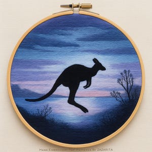 May include: Embroidered hoop art depicting a black kangaroo silhouette against a sunset sky of blues and purples. The artwork is framed in a wooden hoop. The text "Hand Embroidery PDF Patterns by Zazarita" is at the bottom of the artwork.