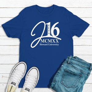 May include: A royal blue t-shirt with a white graphic design. The graphic features the number 16 with the letters "Zeta" inside the number. Below the number is the text "MCMXX Howard University".