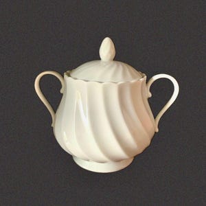 May include: A white porcelain sugar bowl featuring a swirling, ribbed pattern across its rounded body. The vessel includes two curved side handles, a matching lid with a pointed finial, and a scalloped rim edge, all finished in a glossy glaze.