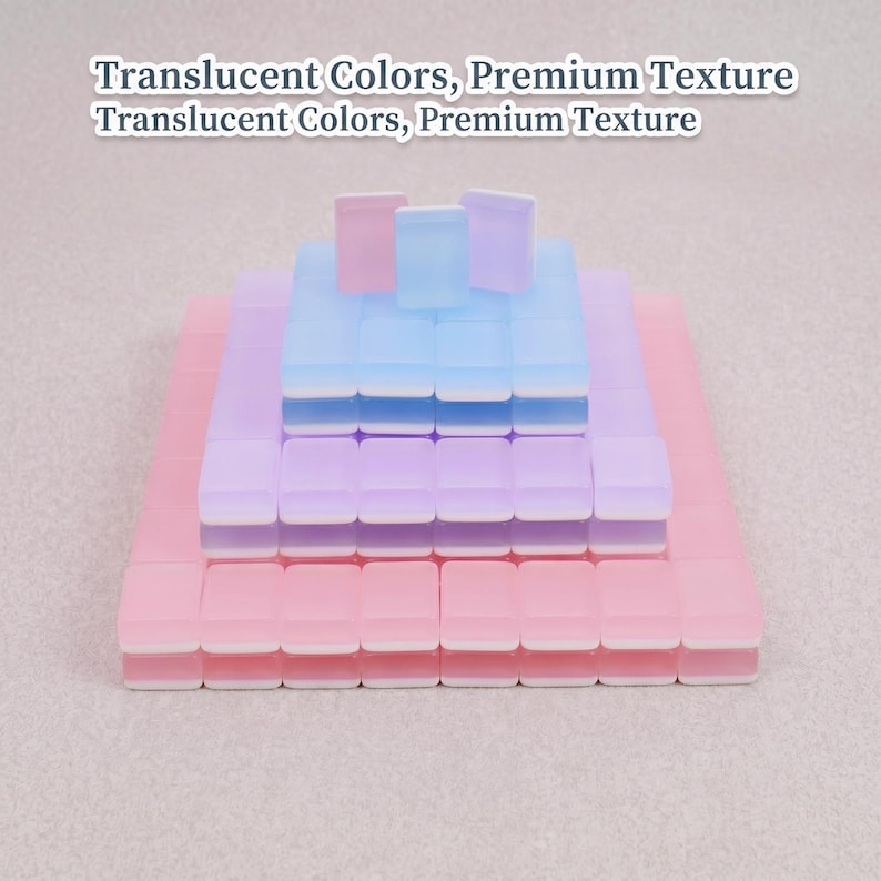 May include: A stack of translucent, pastel-colored square blocks. The blocks are arranged in a tiered formation, with pink, purple, and blue hues. The text "Translucent Colors, Premium Texture" is at the top.