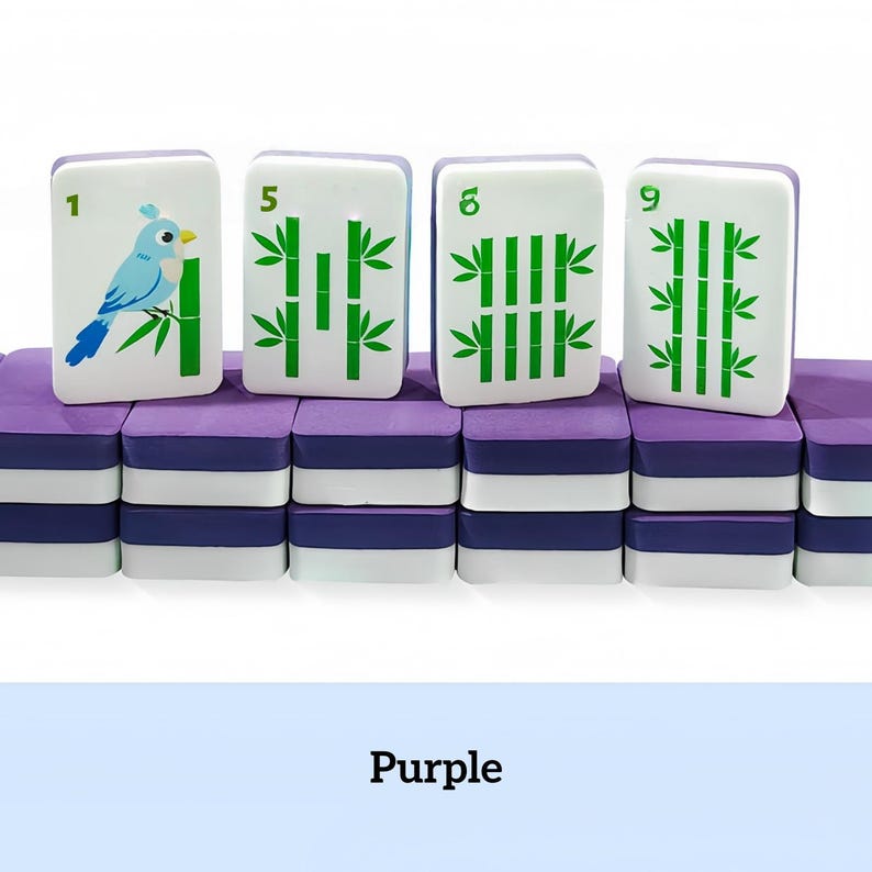 May include: A set of purple and white Mahjong tiles with green bamboo and bird illustrations. The tiles are stacked on a purple base. The numbers 1, 5, 6, and 9 are visible on the tiles. The word "Purple" is at the bottom.