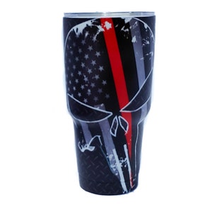 May include: A black and white skull design with an American flag and a red line down the center. The skull is on a black and white stainless steel tumbler.