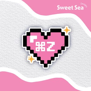 Peut inclure: Un cœur pixelisé rose avec un contour noir et le texte "#Z" à l'intérieur. Deux petites étoiles jaunes sont de chaque côté du cœur.