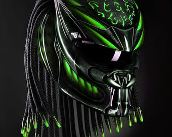 Può includere: Un casco da moto nero con un design Predator verde e bianco. Il casco ha una lunga treccia nera con accenti verdi. Sul casco è scritta la parola "NITRINOS".