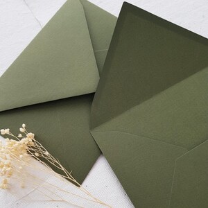 May include: Two green envelopes with a textured finish. The envelopes are folded and ready to be sealed.