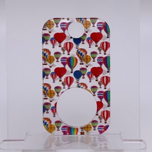 May include: A colorful hot air balloon design printed on a clear acrylic keychain. The keychain has a round hole for attaching keys.