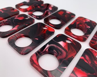 Rectangular Red, black, & white swirl acrylic thread drops. A Crossed In Stitches exclusive.