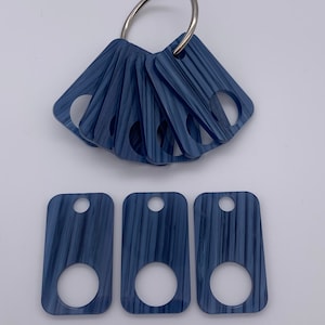 Rectangular blue brushed denim acrylic thread drops.