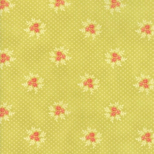 May include: A close-up of a fabric with a light yellow-green background. The fabric has a repeating pattern of small white polka dots and clusters of red flowers with white leaves. The overall design is reminiscent of a vintage floral print.