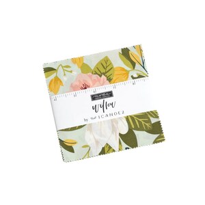 May include: A stack of fabric squares with a floral pattern in shades of pink, yellow, and green. The fabric is wrapped with a white label that reads "willow" by 1canoe2. The fabric squares are designed for quilting and crafting.