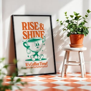May include: A black framed poster with the text "Rise & Shine" in orange and green. A cartoon coffee cup with a face and legs walks across the poster. The text "It's Coffee Time!" is below the cup.
