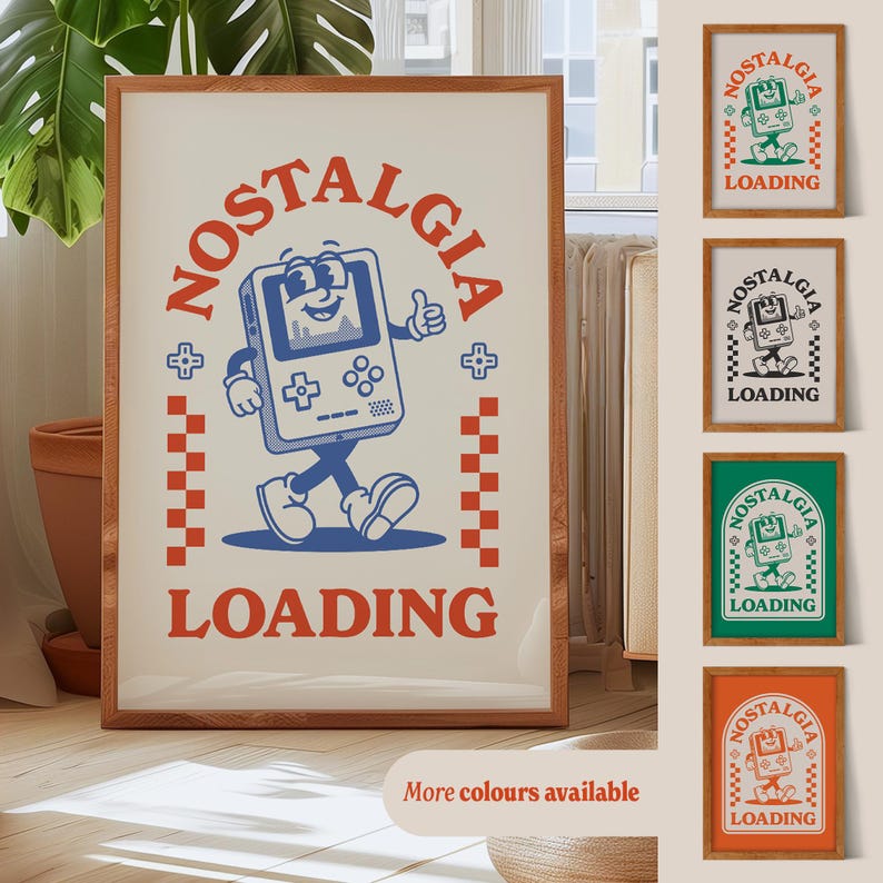 May include: A framed print with a retro design. The artwork features a cartoon game console character with the word "NOSTALGIA" above and "LOADING" below. Additional prints in green, black, and orange are also displayed.