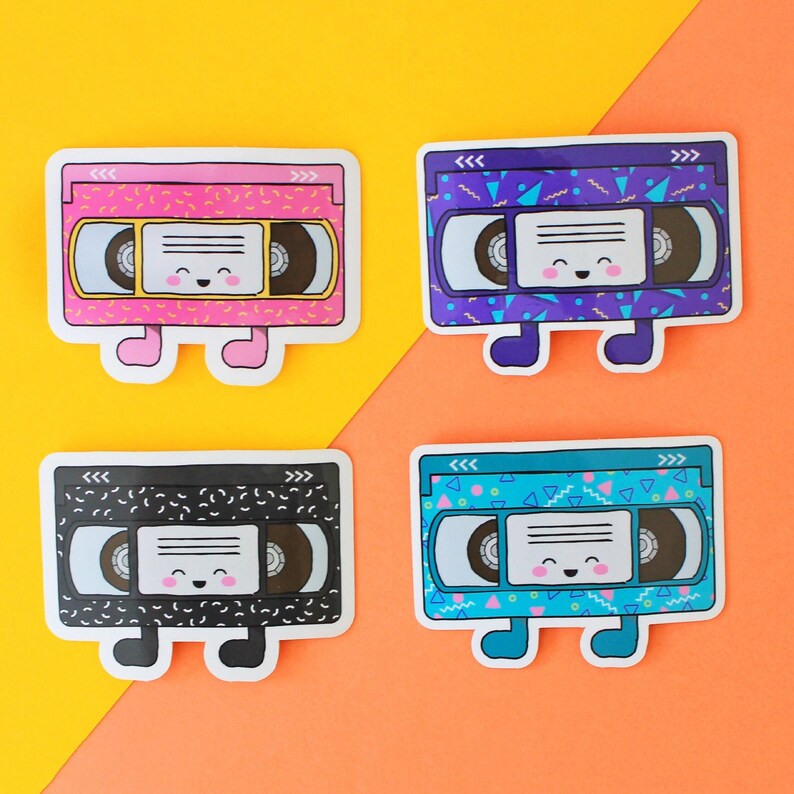 May include: Four colorful cassette tape stickers with a retro 90s design. Each sticker has a smiling face and a different color background: pink, purple, black, and blue.