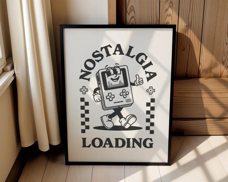 May include: Black framed poster with a retro cartoon graphic of a walking handheld game console giving a thumbs up. The words "NOSTALGIA LOADING" are in a circular design around the character. The background is off-white.