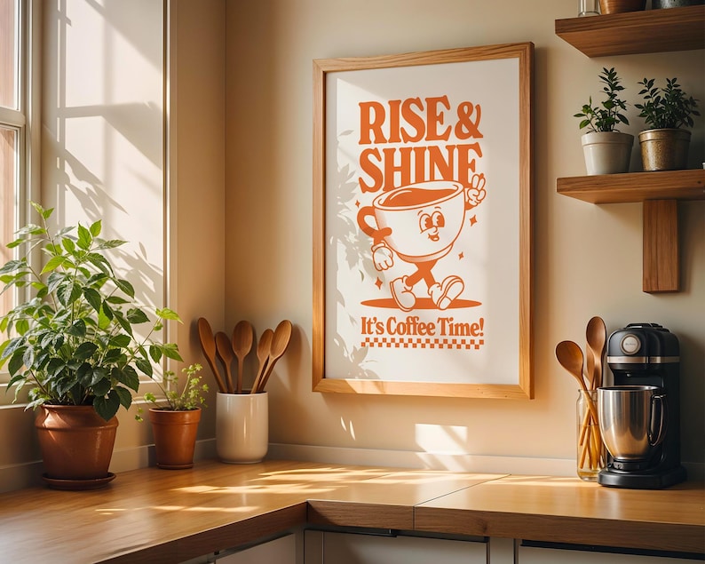 May include: A framed print with the text "Rise & Shine" and a cartoon illustration of a coffee cup with legs and arms. The text below the illustration reads "It's Coffee Time!"