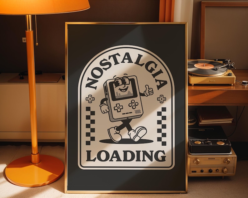 May include: Black framed poster with a retro cartoon graphic of a walking handheld game console with the words "NOSTALGIA LOADING". The design is in black and white with a gold frame.