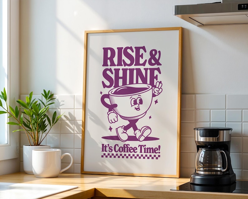 May include: A framed print with a purple cartoon coffee cup character walking and the text "Rise & Shine It's Coffee Time!"
