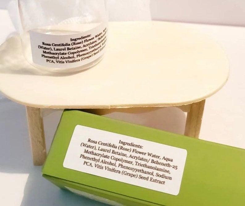 May include: A green and white label with the ingredients for a rose water toner. The ingredients include Rosa Centifolia (Rose) Flower Water, Aqua (Water), Laurel Betaine, Acrylates/Beheneth-25 Methacrylate Copolymer, Triethanolamine, Phenethyl Alcohol, Phenoxyyethanol, Sodium PCA, Vitis Vinifera (Grape) Seed Extract.