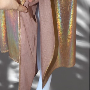 May include: A gold iridescent fabric with a pink lining. The fabric has a subtle sheen and a textured surface.