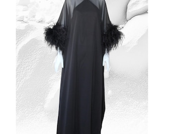 May include: A long black sheer dress with feather trim on the sleeves.
