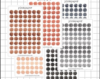 May include: A collection of sticker sheets featuring watercolor dot designs in various colors, including brown, red, gray, and black. Each sheet is labeled with "yin&paper" and a website address.