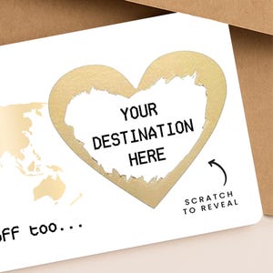 Custom travel gift boarding pass with scratch-to-reveal destination. Includes recipient name “Jordan Goodwin”, date “25.08.2025”, birthday message, and gold heart scratch-off on a world map background. Presented with a brown envelope, ideal for surprise trips, honeymoon gifts, or birthday travel reveals.
