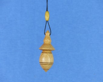 Dowsing pendulum in beech wood