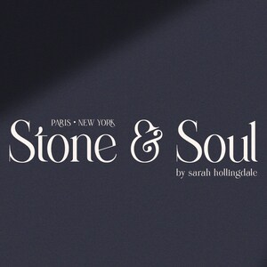 May include: White text on a dark blue background reads "Stone & Soul" with the ampersand stylized as a flourish. Below the text is "by sarah hollingdale".