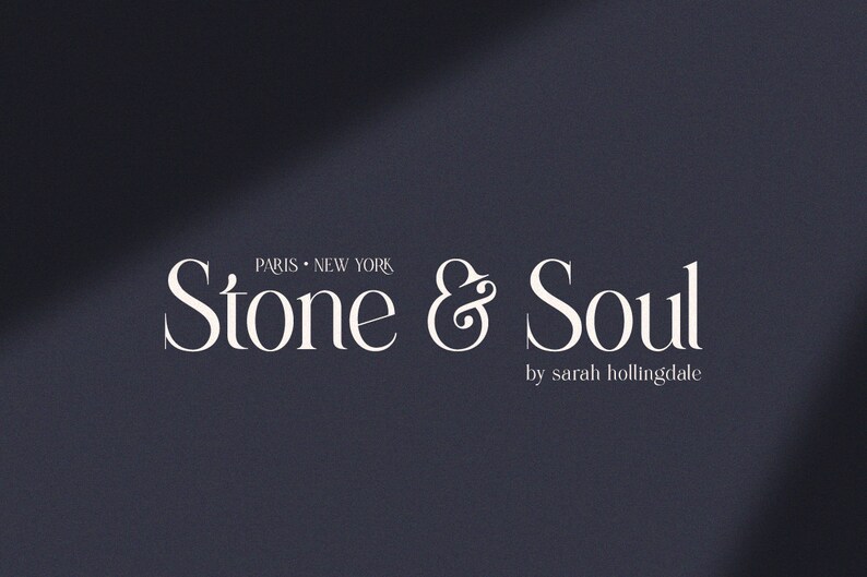 May include: White text on a dark blue background reads "Stone & Soul" with the ampersand stylized as a flourish. Below the text is "by sarah hollingdale".
