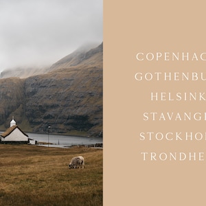 May include: A white church with a grass roof sits on a grassy hill overlooking a body of water. The church is surrounded by rolling hills and a cloudy sky. Two sheep graze in the field.