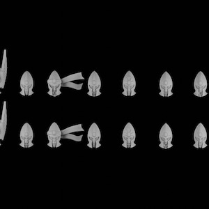 May include: A collection of miniature, gray, fantasy-themed figurines, including winged creatures, helmeted heads with flowing ribbons, and stylized faces. The figurines are arranged against a black background.
