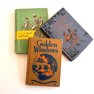 May include: Three vintage children's books. The books are titled "The New Streets and Roads", "A Garden Story", and "Golden Windows". The covers feature illustrations of children, bicycles, and landscapes. The books are in shades of green, blue, and orange.