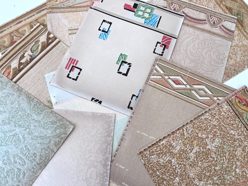 May include: A collection of vintage wallpaper samples in various patterns and colors. The samples include geometric designs, floral motifs, and textured surfaces. Colors range from beige and cream to green and brown.