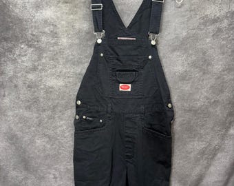 Salopette courte en jean noir style grunge, taille L, vintage années 90/Y2K, de la marque Revolt Clothing.