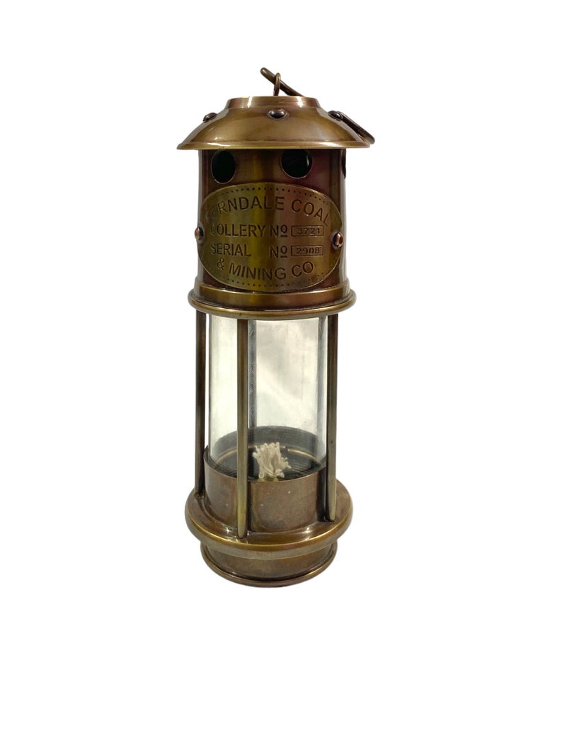May include: Brass miner's lamp with a glass cylinder and a label that reads "Erndale Coal Colliery No. 3721 Serial No. 2900 & Mining Co."
