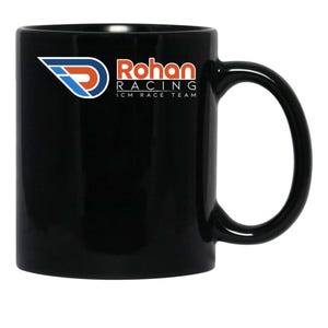 May include: Black ceramic mug with a curved handle. The mug features the text "Rohan Racing ICM Race Team" in red and white, along with a logo in blue, red, and white. The mug is designed for beverages.