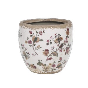 Könnte beinhalten: Ein weißer Keramiktopf mit einer abgenutzten Oberfläche und einem floralen Muster in Rosa-, Gelb- und Grüntönen.