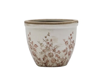 Op de afbeelding: Een witte keramische bloempot met een bruine rand en een bloemmotief in bruintinten. De pot heeft een licht verweerde uitstraling, wat wijst op een vintage stijl. Ideaal voor binnen of buiten.