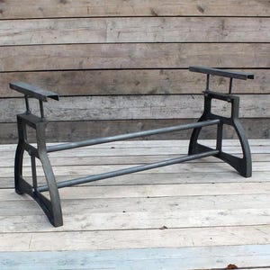 May include: A black metal table base with two horizontal supports and adjustable height. The base is made of sturdy metal and has a rustic industrial style.