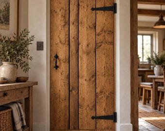 May include: A vertical plank wooden door with a natural brown finish, featuring prominent wood grain and knots. The door is equipped with two black metal strap hinges and a matching black metal handle mounted on the left side.