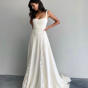 Simple crepe wedding dress with lace detail and train. Boho style aline wedding dress. Custom square neckline wedding dress for brides.