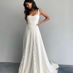 Simple crepe wedding dress with lace detail and train. Boho style aline wedding dress. Custom square neckline wedding dress for brides.